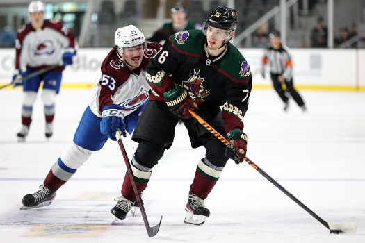 Manix Landry (76) looks to shoot on goal as Ben Tardif (53) defends