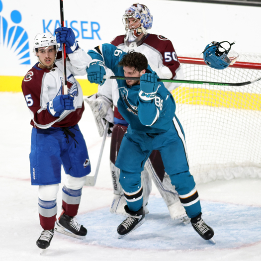 Mark Liwiski (86) loses his helmet as he fights for position in front of the net with Francesco Iasenza (5)