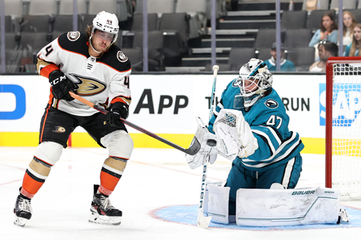 Max Comtois (44) attempts to tip a shot past Sharks' goalie James Reimer (47)