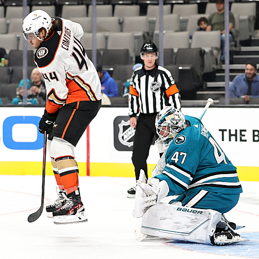 Max Comtois (44) jumps to avoid a shot on net in front of Sharks' goalie James Reimer (47)