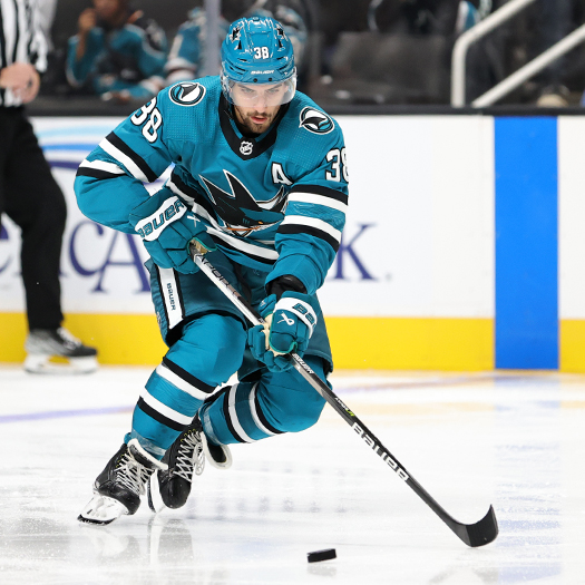 Sharks' defenseman Mario Ferraro looks to control the puck