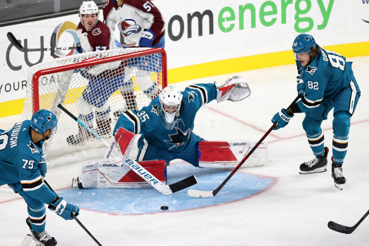 Sharks goalie Mason Beaupit makes a save as Montana Onyebuchi (79) and Artem Guryev (82) look to control the rebound