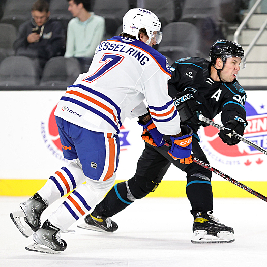 Derrick Pouliot (55) takes a shot on goal as Michael Kesselring (7) defends