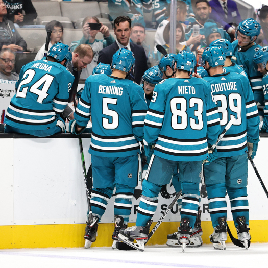 Sharks coach Davis Quinn discusses strategy with his team during a 3rd period timeout
