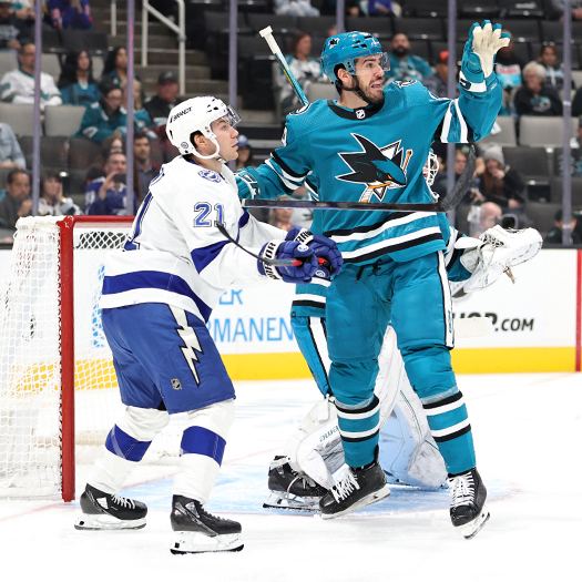 Sharks defenseman Jaycob Megna (24) reaches for a loose puck into front of Brayden Point (21)