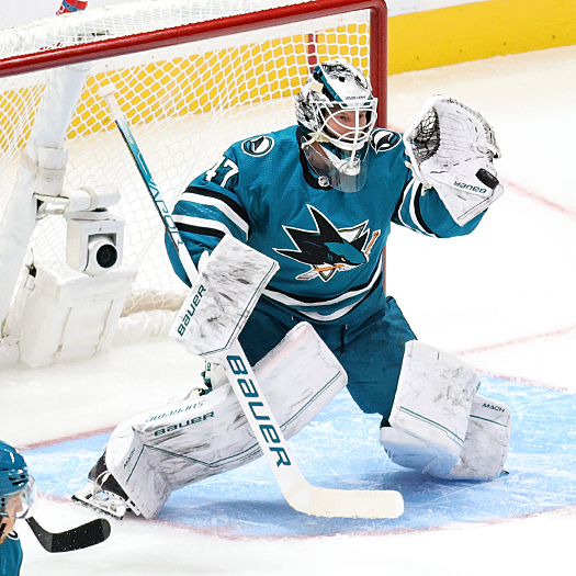 Sharks goalie James Reimer makes a glove save during first period action