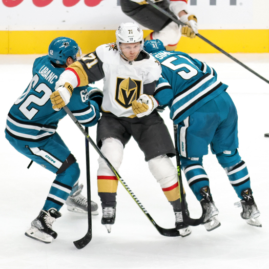 William Karlsson (71) tries to avoid a check from Sharks players Kevin Labanc (62) and Radium Simek (51)