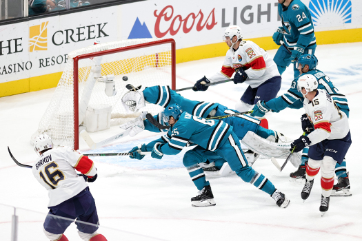 Aleksander Barkov (16) fires a shot past sharks defenseman Erik Karlsson (65) and diving goalie James Reimer for a first period goal