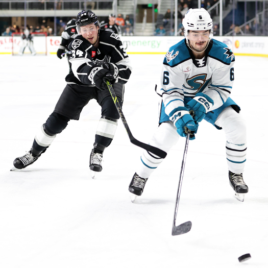 Barracuda's defenseman Ryan Merkley (6) moves the puck away from Taylor Ward (34)