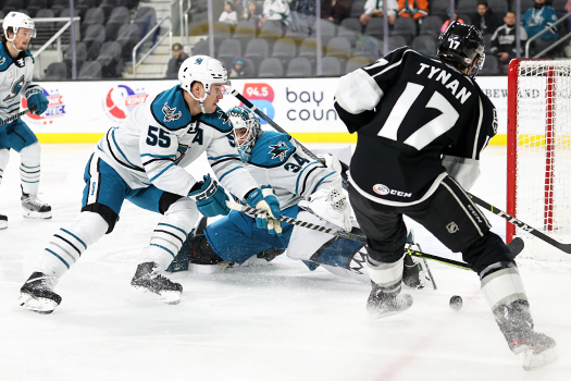 Barracuda's goalie Strauss Mann (34) makes a kick save on a shot by TJ Tynan (17) as defenseman Derrick Pouliot (55) looks to clear the rebound