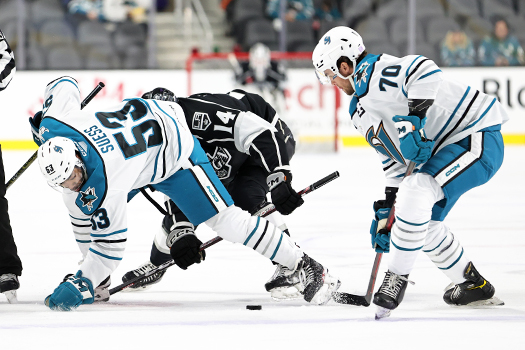 C.J. Suess (53) and Brandon Coe (70) try to control the puck after a faceoff