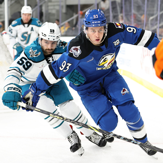 Jean-Luc Foudy (93) and Nick Cicek (59) chase the puck in the corner