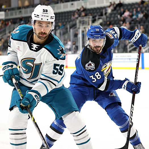 Nick Cicek (59) and Spencer Smallman (38) follow the puck into the corner
