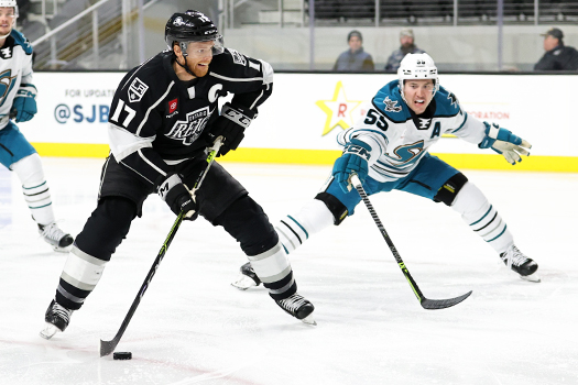 Reign Captain T.J. Tynan (17) takes a shot on goal as Derrick Pouliot (55) defends