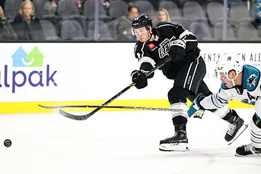 Taylor Ward (34) follows through on a shot on goal as Derrick Pouliot (55) tries to block the shot