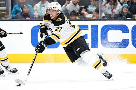 Bruins defenseman Hampus Lindholm fires a pass up ice