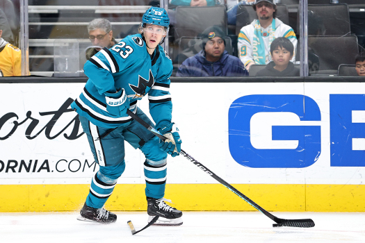 Oskar Lindblom looks to make a pass as he tries to avoid a loose stick at his feet