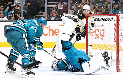 Sharks' goalie James Reimer dives across the crease to make a save on a shot by Charlie McAvoy (73)