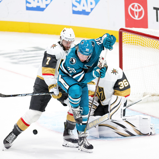 Sharks forward Fabian Zetterlund (20) attempts to tip a shot past Golden Knights goalie Logan Thompson as Alex Pietrangelo (7) defends