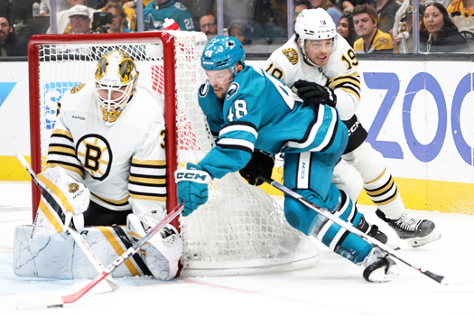 Sharks forward Tomas Hertl (48) attempts a wrap-around shot on goalie Linus Ullmark as John Beecher (19) defends