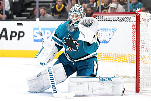 Sharks goalie Kaapo Kahkonen keeps his eyes on the puck before making a glove save