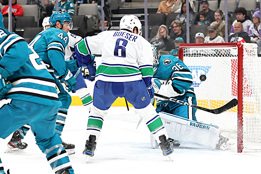 Brock Boeser (6) scores his second goal of the first period on a shot past goalie Kaapo Kahkonen