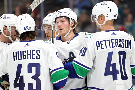 Brock Boeser (center) celebrates his second goal of the game goal with teammates