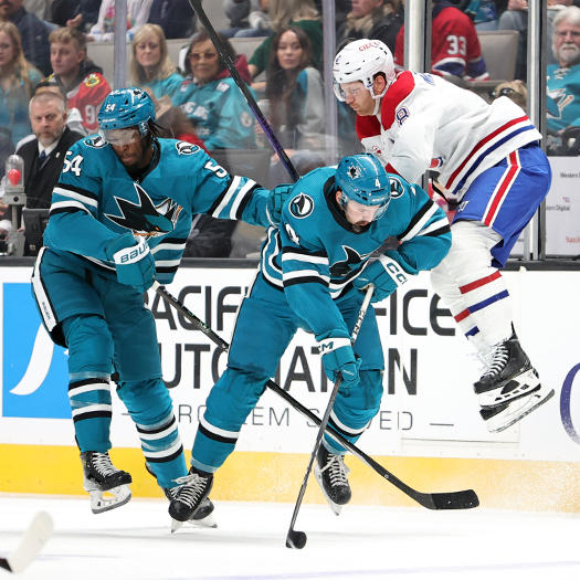 Canadians defenseman Mike Matheson (right) jumps to avoid a check from Givani Smith (54) and Kyle Burroughs (4)