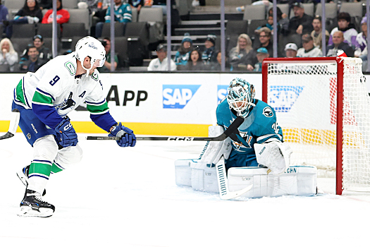 JT Miller (9) scores a goal past Sharks goalie Kappo Kahkonen during first period action