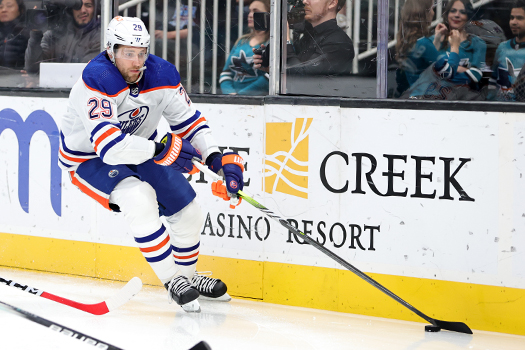 Leon Draisaitl moves the puck around the net