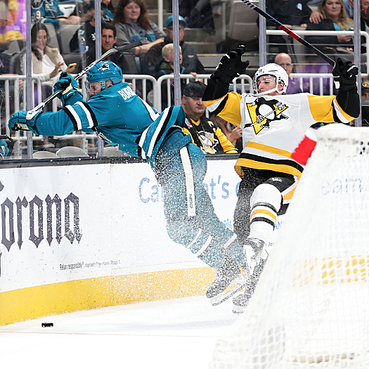 Noel Acciari (right) checks Kyle Burroughs (4) from behind
