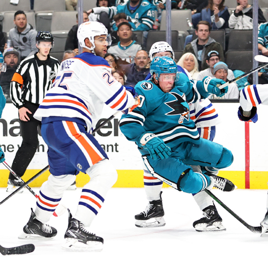 Oilers defenseman Darnell Nurse (25) checks Sharks forward Fabian Zetterlund (20)