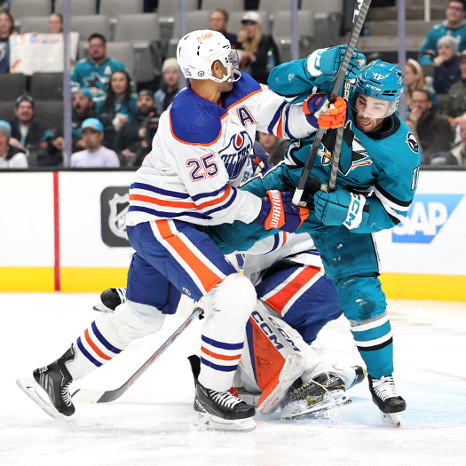 Oilers defenseman Darnell Nurse (25) moves Luke Kunis (11) away from the front of the net