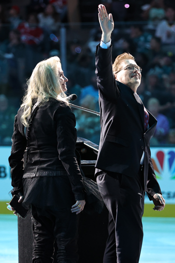 Sharks' broadcaster Dan Rusanowksky, accompanied by his wife Karen, is honored in a pre-game ceremony for winning the 2023 Foster Hewit Memorial Award