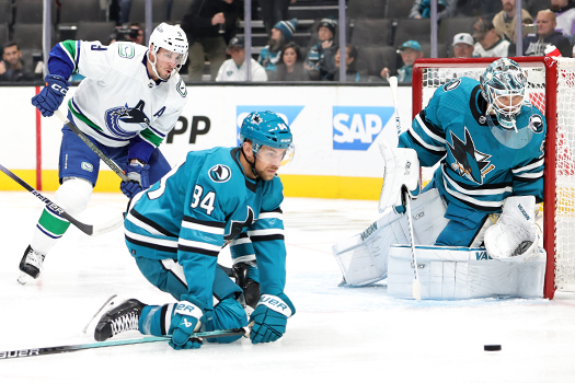 Sharks defenseman Jan Rutta (84) attempts to block a pass intended for JT Miller (9) in front of Sharks goalie Kappo Kahkonen