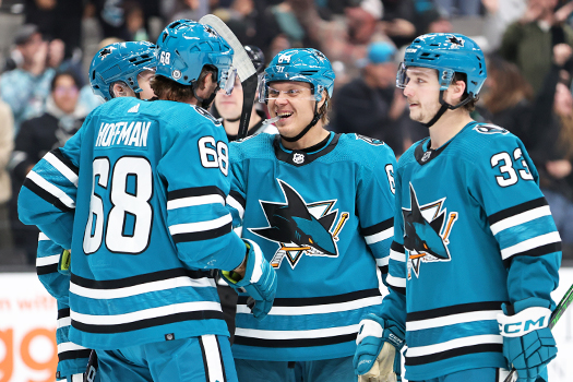 Sharks forward Mike Hoffman (68) celebrates his goal with Mikael Granlund (64) and Calen Addision (33)