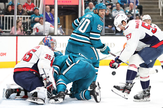 Sharks forwards Luke Kunin (11) and Justin Bailey (90) look for the rebound in front of goalie Darcy Kuemper as Trevor van Riemsdyk (57) attempts to clear the puck