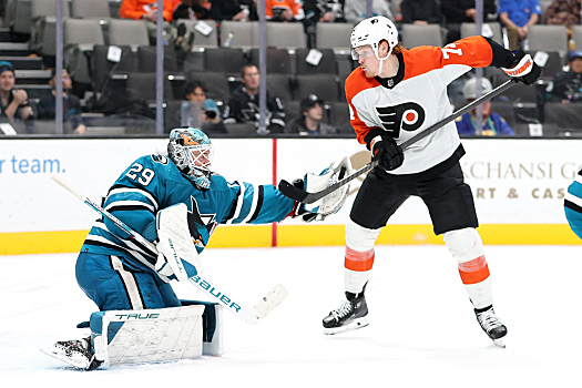 Sharks goalie Mackenzie Blackwood makes a glove save as Flyers forward Owen Tippett (74) attempts to swipe the puck out of his glove