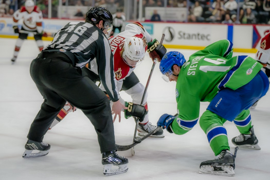 Josh Doan of Tucson and John Stevens of Abbotsford fight for a faceoff win