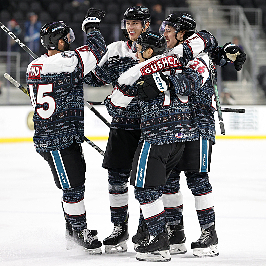 Shakir Mukhamadullin (center) celebrates his second period goal with teammates Nathan Todd (45) Danil Gushchin (75) and Leon Gawanke (26)
