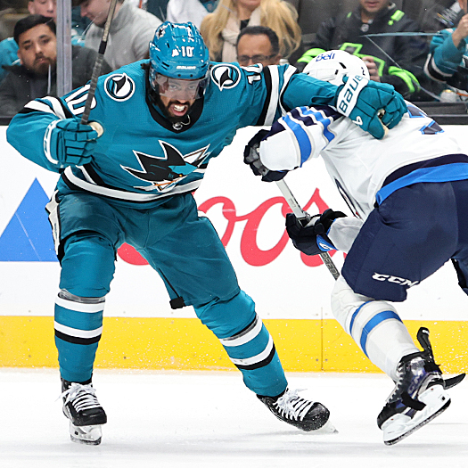 Sharks forward Anthony Duclair (10) attempts to move around Jets defenseman Dylan DeMelo (right)
