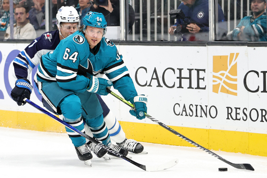 Sharks forward Mikael Granlund (64) moves the puck up ice past Vladislav Namestnikov (7)