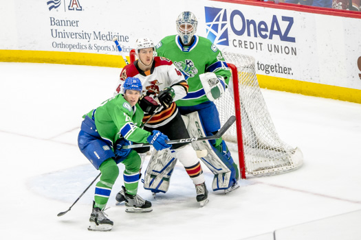Tucson winger Austin Poganski battles for position with Abbotsford captain Chase Wouters