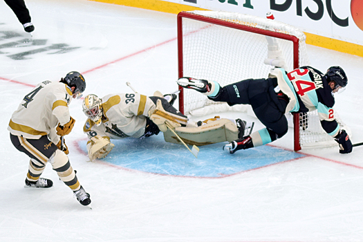 Golden Knight goalie Logan Thompson (36) stops a shot by Jamie Oleksiak (24) as defenseman Nicolas Hague (14) controls the rebound