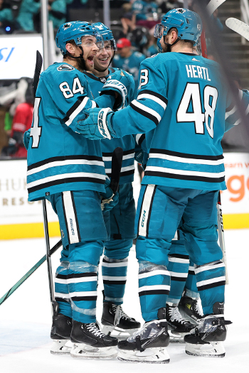 Jan Rutta (84) celebrates his third period goal with teammates Henry Thrun (center) and Tomas Hertl (48)