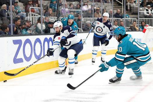 Jets defenseman Dylan DeMelo (2) moves the puck away from Anthony Duclair (10)