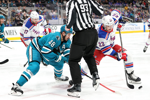Jonny Brodzinski (22) wins a face-off against Tomas Hertl (48)