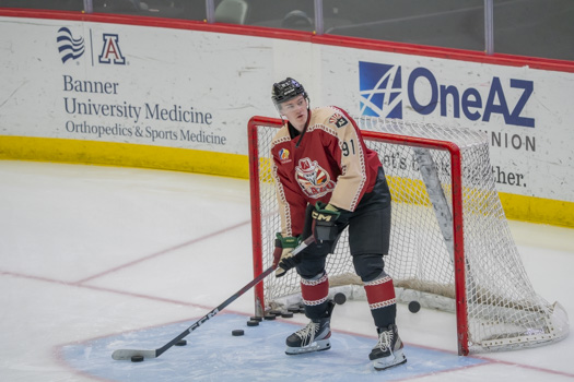 Josh Doan dishing some pucks to teammates during warmups