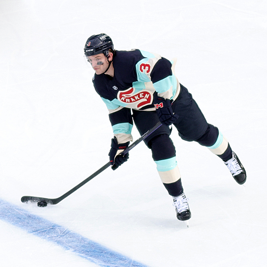 Kraken defenseman Will Borgen shoots the puck up ice