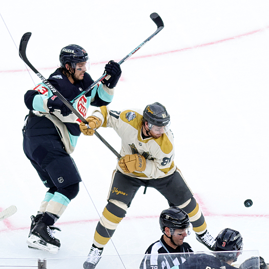 Kraken forward Brandon Tanev and Golden Knight Jonathan Marchessault (81) battle for the puck after a face-off
